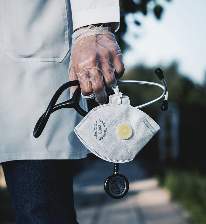 Doctor with mask and stethoscope in hand